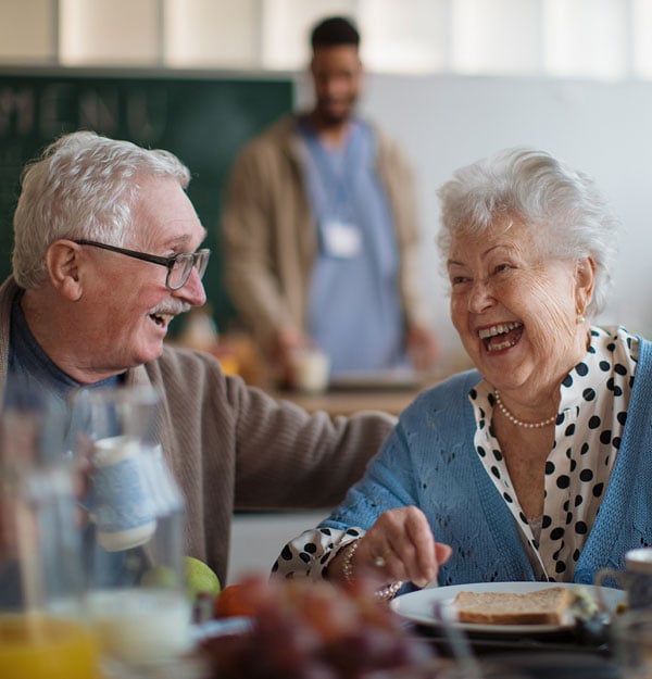 smiling-elderly-woman-and-man-enjoying-breakfast smiling-elderly-woman-and-man-enjoying-breakfast